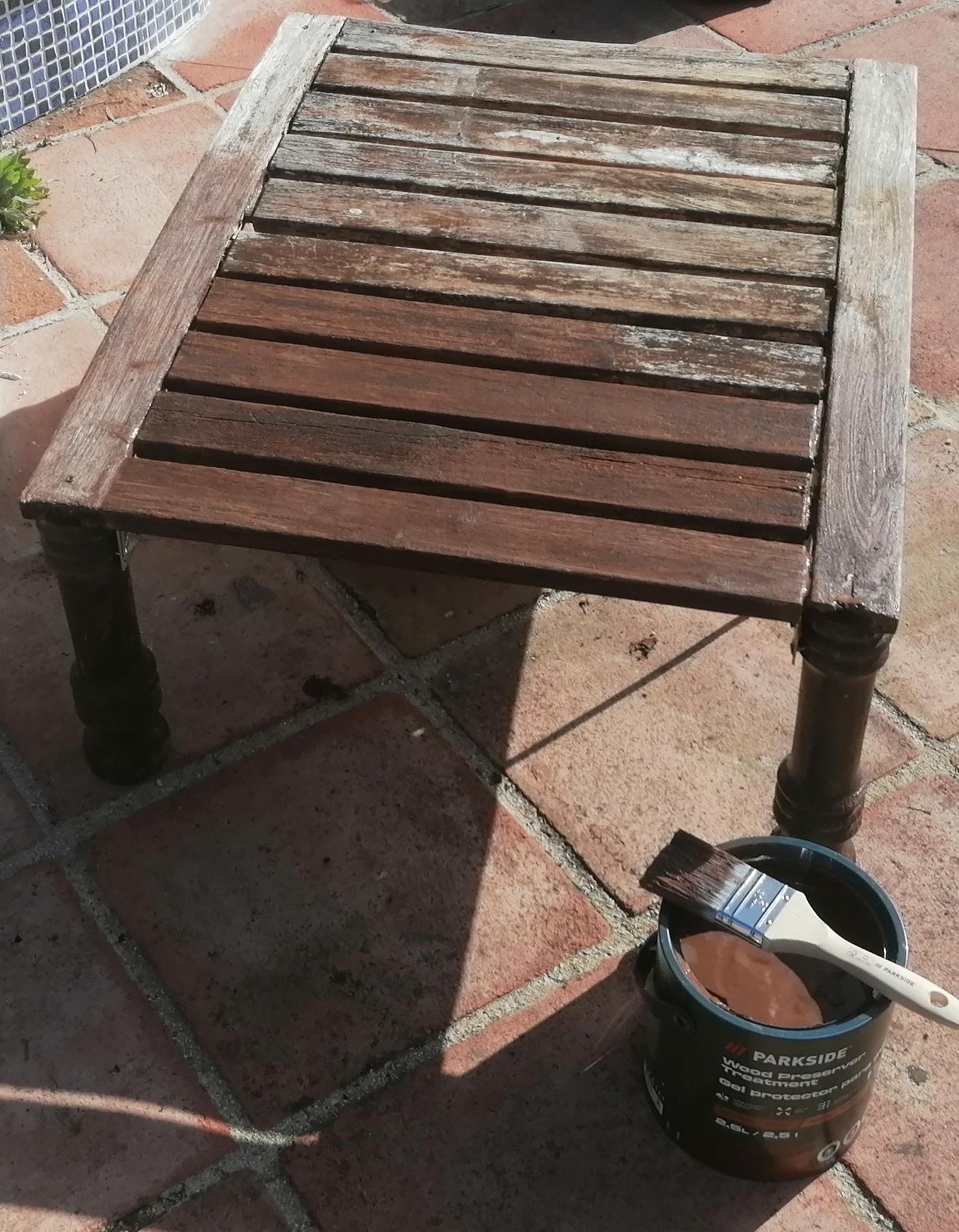 A puréed and simmering carrot soup in a pot with a spoon